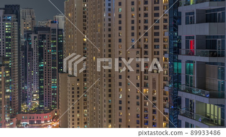 Overview to JBR and Dubai Marina skyline with modern high rise skyscrapers waterfront living apartments aerial night timelapse 89933486