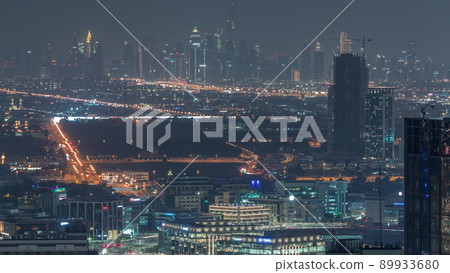 Dubai Downtown skyline row of skyscrapers with tallset tower aerial night timelapse. UAE Dubai Downtown skyline row of skyscrapers with tallset tower aerial night timelapse. UAE 89933680