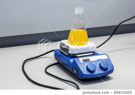 laboratory flask with liquid vibrates and is stirred in the laboratory laboratory flask with liquid vibrates and is stirred in the laboratory 89935809
