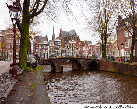 Beautiful old houses on the city waterfront of Amsterdam at sunset. Beautiful old houses on the city waterfront of Amsterdam at sunset. 89936626