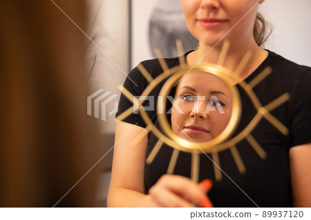 Smiling Beautician Holding Mirror For Female Customer Smiling Beautician Holding Mirror For Female Customer 89937120