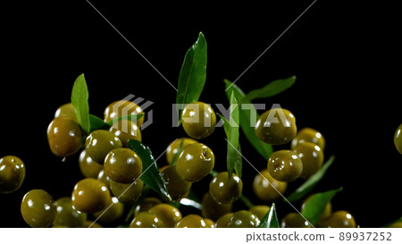 Freeze motion of flying green olives. 89937252