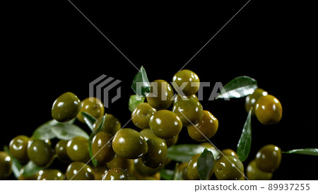Freeze motion of flying green olives. 89937255