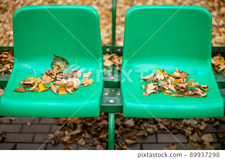 Empty sports stands with red and green seats on an autumn day. Empty sports stands with red and green seats on an autumn day. 89937298