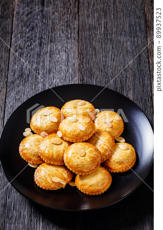 almond cookies on black plate, top view almond cookies on black plate, top view 89937523