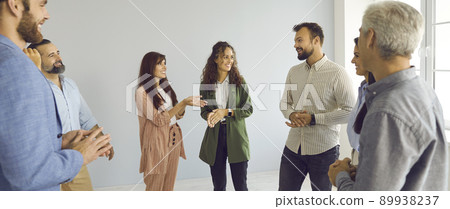 Group of happy people having a discussion during a break at a business conference Group of happy people having a discussion during a break at a business conference 89938237
