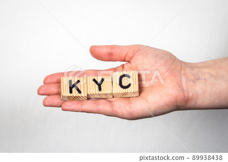 KYC Know Your Customer. Alphabet letters in a woman's hand on a white background 89938438