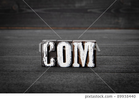 COM. Domain name concept. Word from wooden blocks on a dark background 89938440