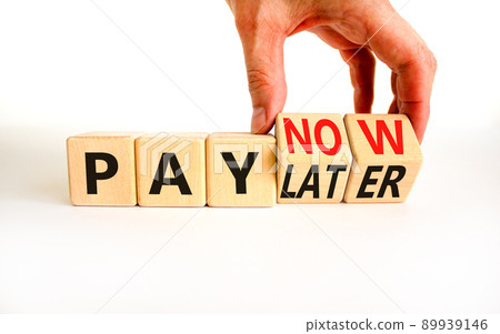 Pay later or now symbol. Businessman turns wooden cubes and changes concept words Pay later to Pay now. Beautiful white table white background. Business pay later or now concept. Copy space. 89939146