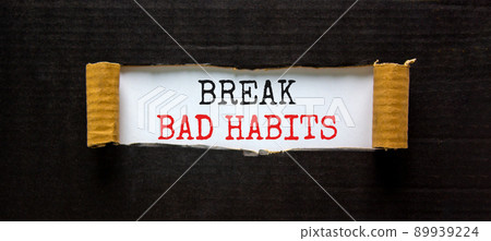 Break bad habits symbol. Words 'Break bad habits' appearing behind torn black paper. Beautiful black background. Business, psychology and break bad habits concept, copy space. Break bad habits symbol. Words 'Break bad habits' appearing behind torn black paper. Beautiful black background. Business, psychology and break bad habits concept, copy space. 89939224