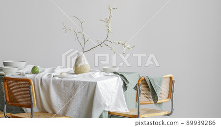 Elegant table setting with cherry brunch in craft vase , cherimoya fruits, garlic in craft ceramic plate on linen tablecloth. Outdoor table setting for summer holiday concept. 89939286