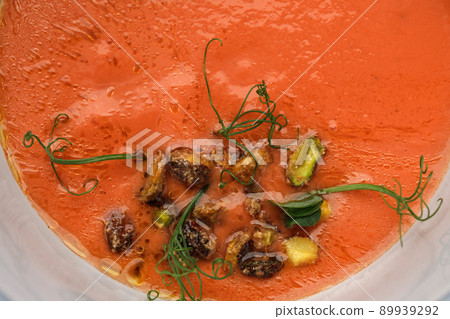 Bowl of cold tomato gazpacho soup with pistachios. Summer refreshing food concept 89939292