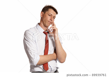 Young man in a classic white shirt and red tie posing isolated on white background. Young man in a classic white shirt and red tie posing isolated on white background. 89939761