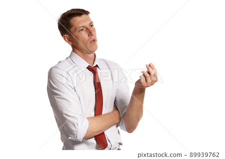 Young man in a classic white shirt and red tie posing isolated on white background. Young man in a classic white shirt and red tie posing isolated on white background. 89939762