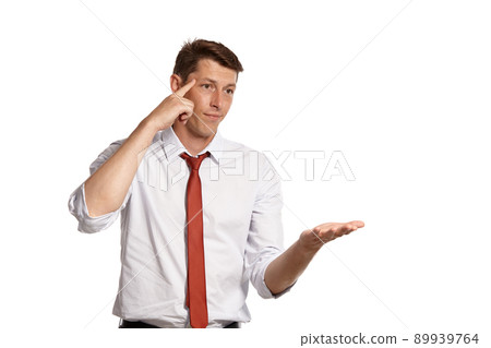 Young man in a classic white shirt and red tie posing isolated on white background. Young man in a classic white shirt and red tie posing isolated on white background. 89939764