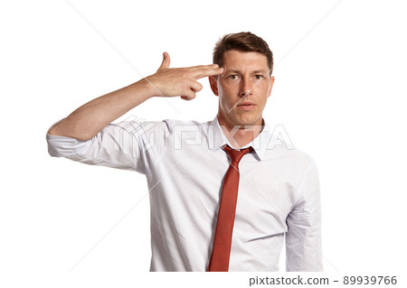 Young man in a classic white shirt and red tie posing isolated on white background. Young man in a classic white shirt and red tie posing isolated on white background. 89939766