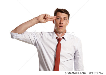 Portrait of a young brunet man posing in a studio isolated over a white background. 89939767