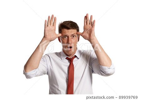 Portrait of a young brunet man posing in a studio isolated over a white background. Portrait of a young brunet man posing in a studio isolated over a white background. 89939769