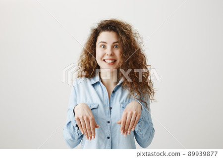 Funny girl showing bunny hands with her hands isolated on gray background Funny girl showing bunny hands with her hands isolated on gray background 89939877