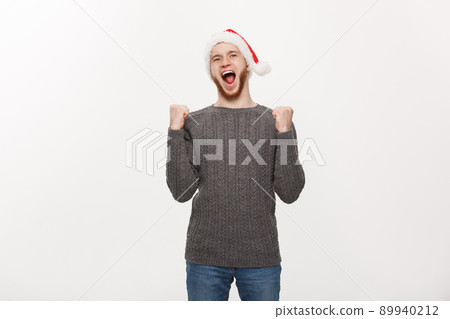 Holiday Concept - Young beard man in sweater showing hand up with exciting feeling. 89940212