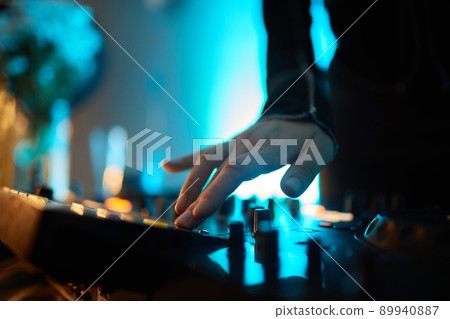 Hands of female Dj playing music on modern midi controller turntable. Digital device for mixing music on events and in studio. Hands of female Dj playing music on modern midi controller turntable. Digital device for mixing music on events and in studio. 89940887