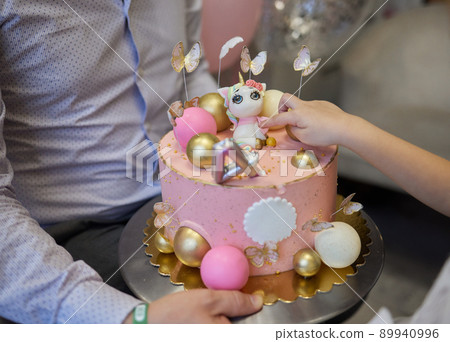 kendi bar on children's birthday. cake with unicorn and sweets, ornaments in gentle pastel tones. 89940996