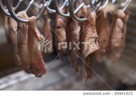 Close up of a smoked meat and belly or beech meat with dark crust in the smokehouse or smoker, food concept. Close up of a smoked meat and belly or beech meat with dark crust in the smokehouse or smoker, food concept. 89941025