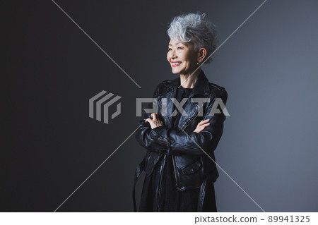 Gray-haired woman in a rider's jacket 89941325