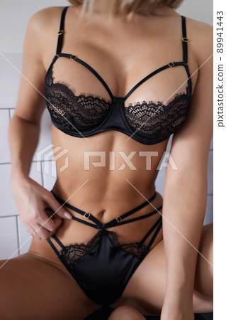 young woman in lingerie in her kitchen. 89941443