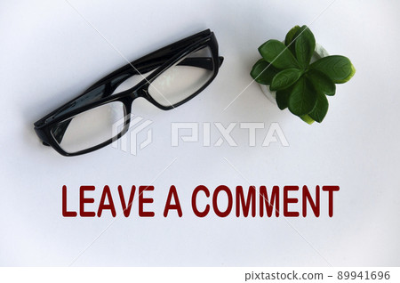 Leave a comment text on light white cover with potted plant and glasses background. Leave a comment text on light white cover with potted plant and glasses background. 89941696