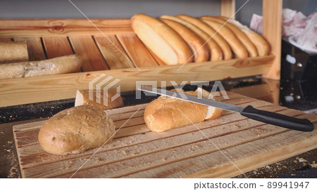 Bread loafs at wooden cutting board Bread loafs at wooden cutting board 89941947