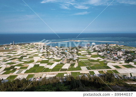 high view from Thoi Loi Mountain, fishing village and garlic fields at Ly Son island, Quang Ngai Province, Viet Nam 89944037