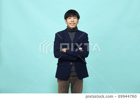 young Southeast Asian man in light blue studio isolated background 89944760