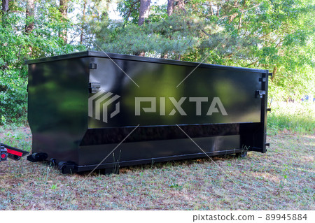 Construction trash dumpsters in an metal container, home house renovation. Construction trash dumpsters in an metal container, home house renovation. 89945884