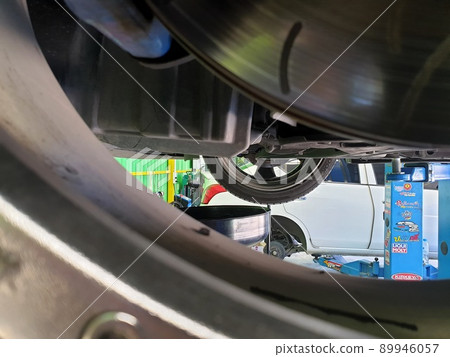Car mechanic drain the old lubricant engine oil Car mechanic drain the old lubricant engine oil 89946057