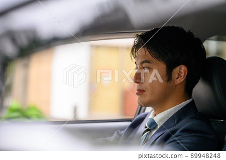 Male businessman driving a car Male businessman driving a car 89948248