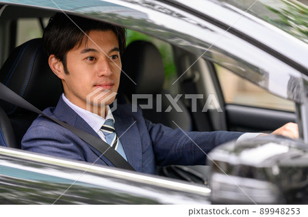 Male businessman driving a car 89948253