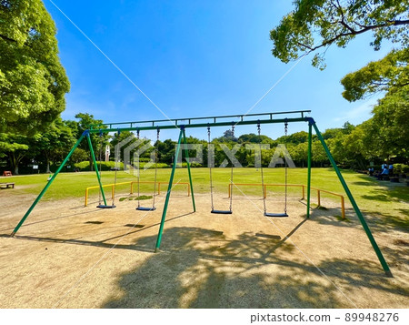 Summer blue sky, green grass and swing Summer blue sky, green grass and swing 89948276