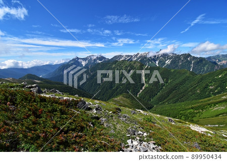 A large panorama of Mt. Hotaka and Mt. Yari seen from the mountain trail leading to Mt. Otensho 89950434