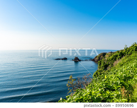 Beautiful view of the Sea of Japan in early summer, calm sea and cape 89950696