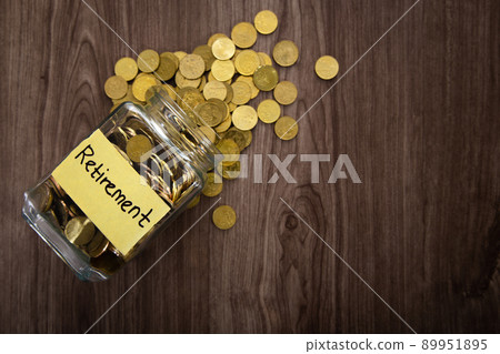 Coin glass jar container on wooden desk, retirement saving concept 89951895