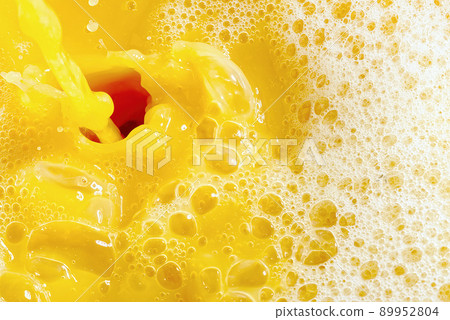 Closeup of splashing orange juice, top view. Splash of fresh sweet orange, mango, fruit juice. Closeup of splashing orange juice, top view. Splash of fresh sweet orange, mango, fruit juice. 89952804