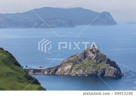Rocky Gaztelugatxe is islet on coast of Biscay connected to emerald mainland cape cabo Matxitxako Rocky Gaztelugatxe is islet on coast of Biscay connected to emerald mainland cape cabo Matxitxako 89953298