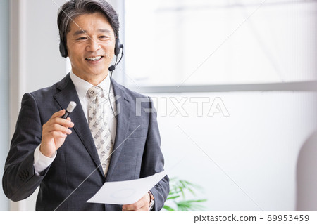 A business person who wears a headset and talks in public A business person who wears a headset and talks in public 89953459