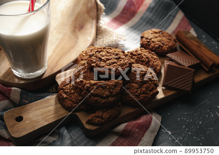 Top view of milk bottle with cookies on wooden board Top view of milk bottle with cookies on wooden board 89953750