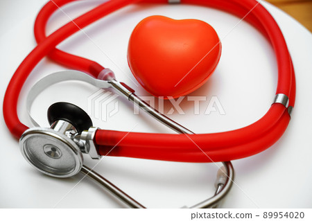 Stethoscope and red heart on white background, heart health, health insurance concept Stethoscope and red heart on white background, heart health, health insurance concept 89954020