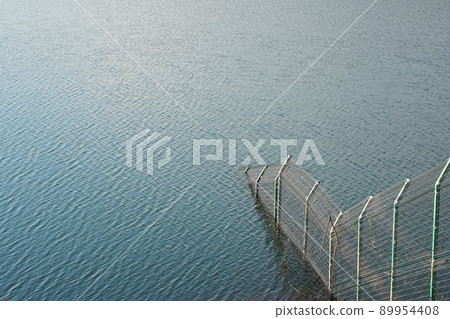 A fence leading to the bottom of the Sayama Lake Dam A fence leading to the bottom of the Sayama Lake Dam 89954408