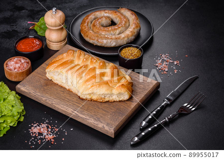 Traditional Ukrainian cabbage pie on a dark concrete background. Baked homemade pie with cabbage 89955017