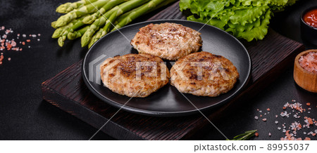 Flat lay composition with grilled meat cutlets for burger on black concrete table 89955037