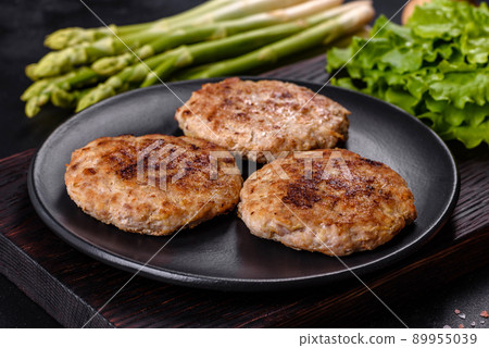 Flat lay composition with grilled meat cutlets for burger on black concrete table Flat lay composition with grilled meat cutlets for burger on black concrete table 89955039